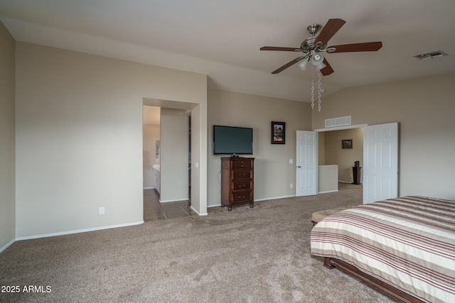 unfurnished bedroom featuring visible vents, baseboards, carpet flooring, and vaulted ceiling