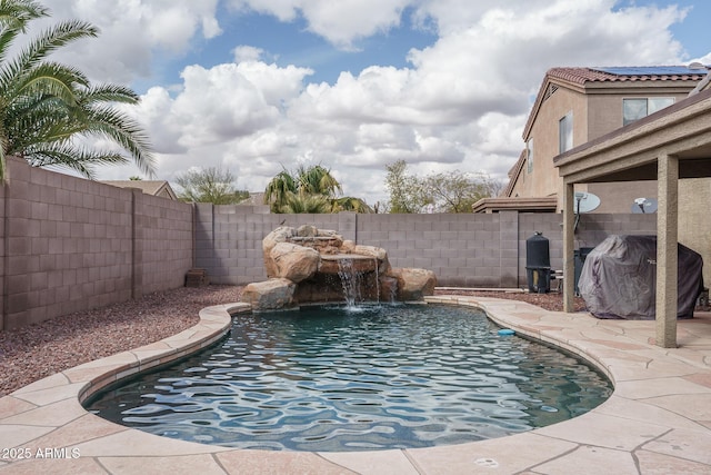 view of pool with area for grilling, a fenced in pool, and a fenced backyard