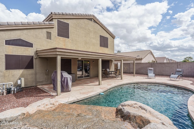 view of pool with a fenced backyard, grilling area, and a patio