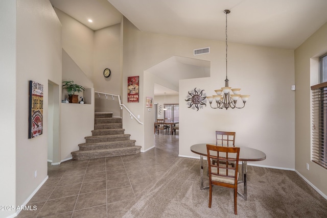 tiled dining room with a chandelier, visible vents, stairway, and baseboards