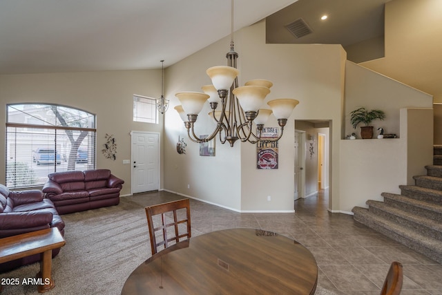 tiled dining room with visible vents, high vaulted ceiling, a notable chandelier, baseboards, and stairs