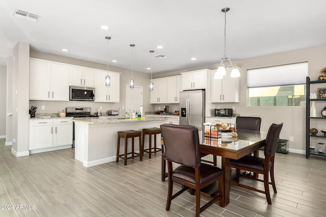 dining area featuring an inviting chandelier and light hardwood / wood-style floors