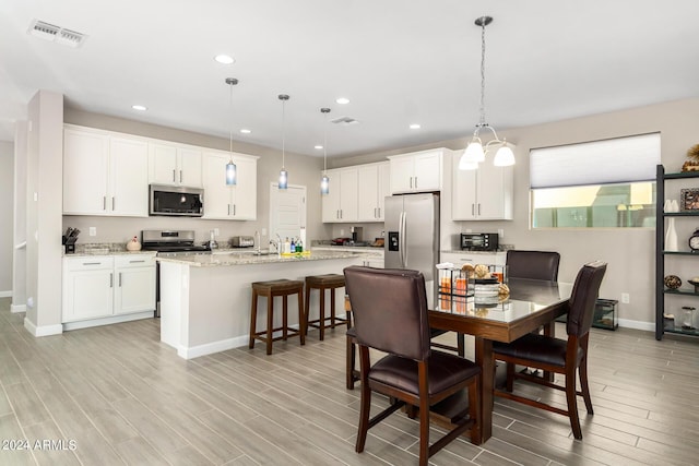 1906 W Lariat Ln, Phoenix, AZ 85085 - dining space featuring baseboards, visible vents, wood finish floors, and recessed lighting