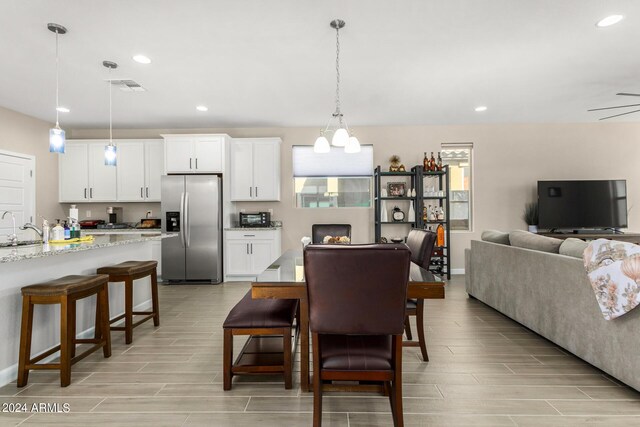 dining room featuring sink and light hardwood / wood-style flooring