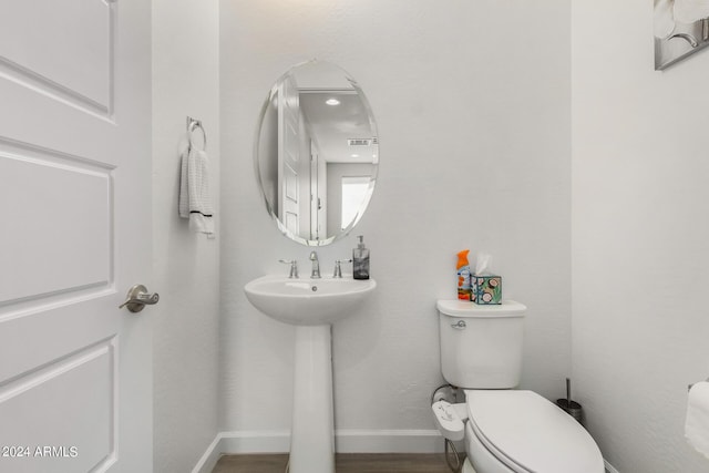 1906 W Lariat Ln, Phoenix, AZ 85085 - bathroom with baseboards, wood finished floors, toilet, and a sink