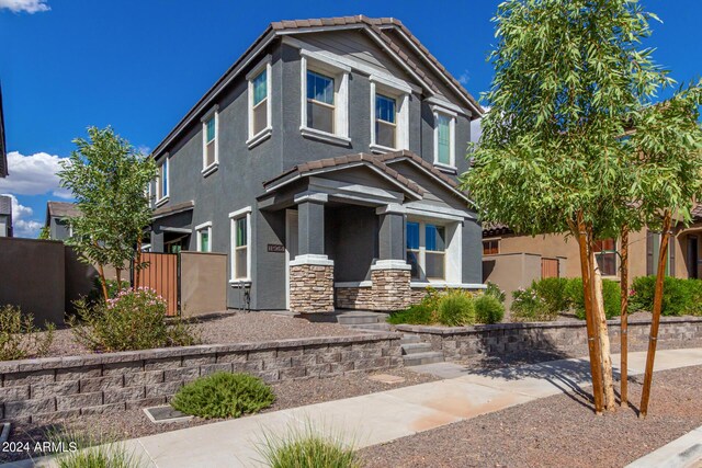 1906 W Lariat Ln, Phoenix, AZ 85085 - view of front of house with stone siding, a tile roof, fence, and stucco siding