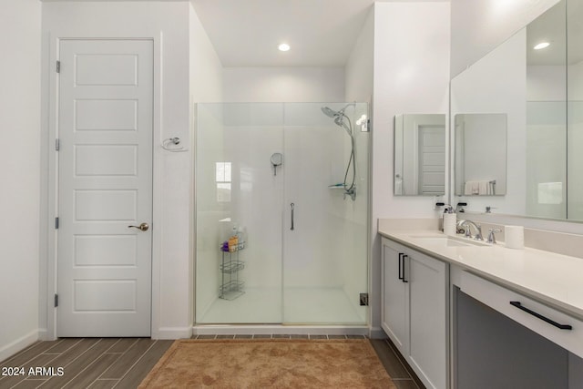 1906 W Lariat Ln, Phoenix, AZ 85085 - bathroom with wood finish floors, vanity, a stall shower, and recessed lighting
