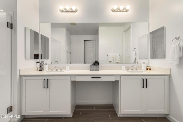 1906 W Lariat Ln, Phoenix, AZ 85085 - full bathroom featuring baseboards, double vanity, a sink, and wood finish floors