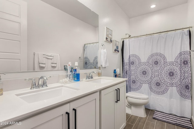 bathroom featuring a shower with curtain, vanity, hardwood / wood-style floors, and toilet