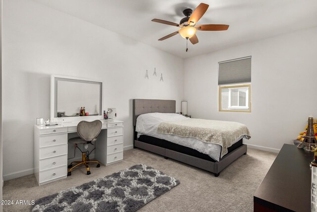 bedroom with ceiling fan and light carpet