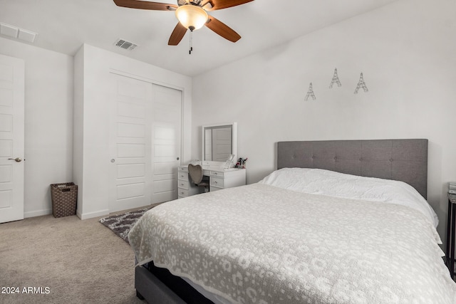 carpeted bedroom featuring ceiling fan and a closet