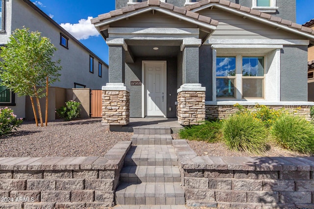 1906 W Lariat Ln, Phoenix, AZ 85085 - view of front of home featuring stone siding, a gate, and stucco siding