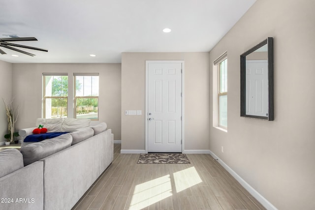 living room with light wood-type flooring and ceiling fan