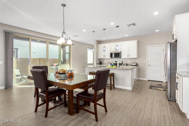 dining area with light wood-type flooring