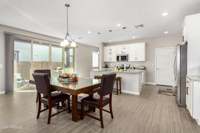1906 W Lariat Ln, Phoenix, AZ 85085 - dining area featuring wood tiled floor, recessed lighting, baseboards, and visible vents