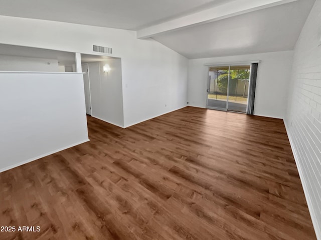 unfurnished living room featuring dark hardwood / wood-style flooring and vaulted ceiling with beams