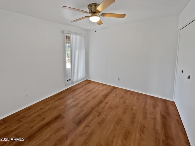 spare room with ceiling fan and wood-type flooring