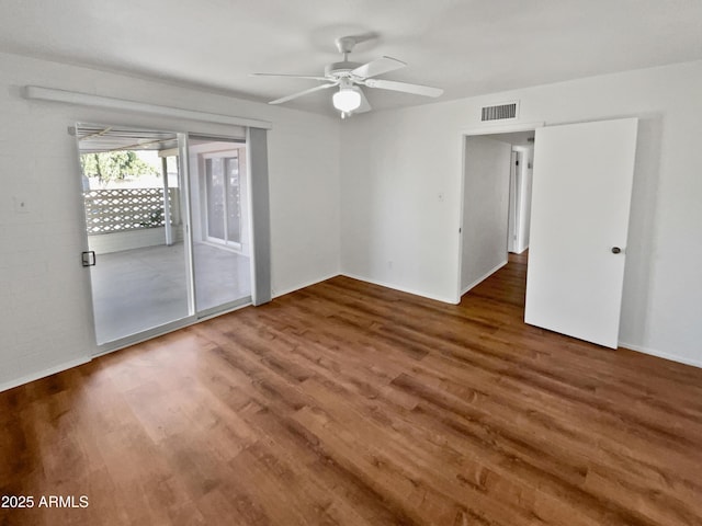 spare room featuring dark hardwood / wood-style flooring and ceiling fan