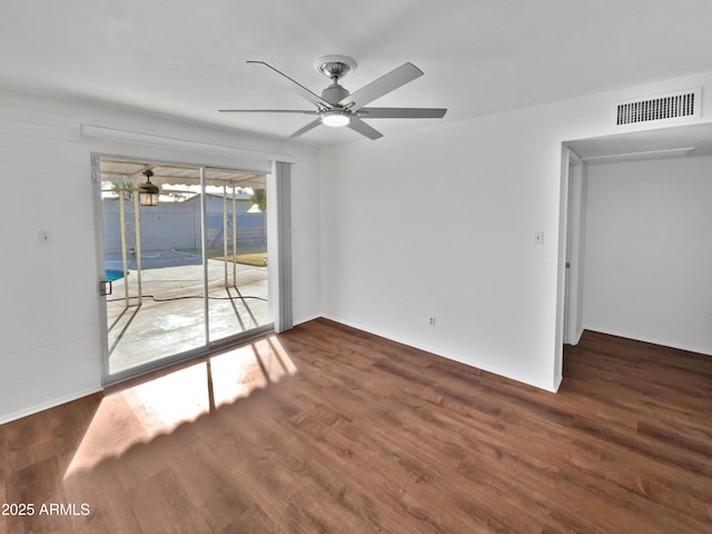 empty room with dark wood-type flooring and ceiling fan
