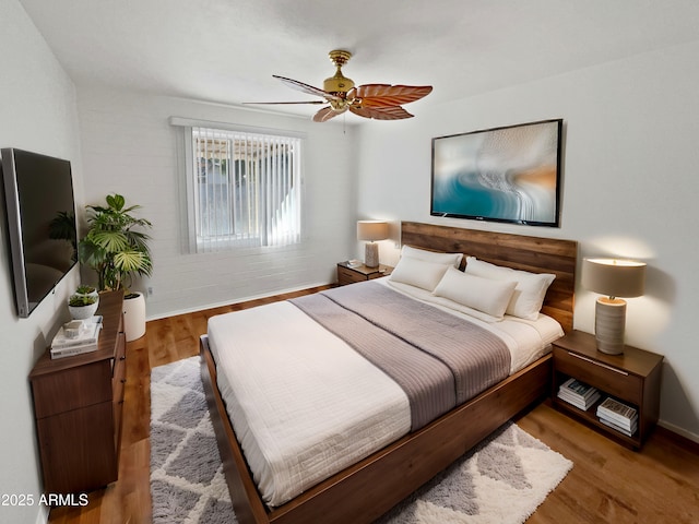 bedroom with hardwood / wood-style flooring and ceiling fan