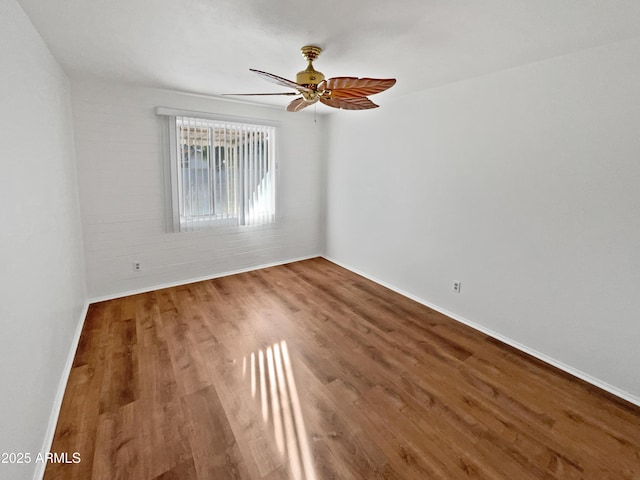 empty room featuring hardwood / wood-style floors and ceiling fan