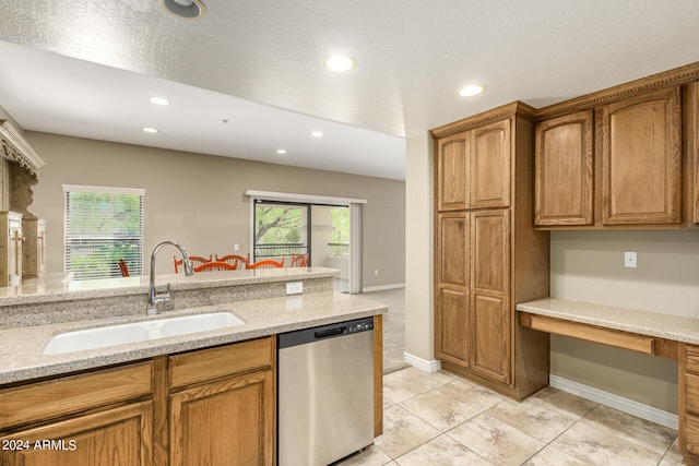 kitchen with a sink, light stone countertops, dishwasher, and recessed lighting