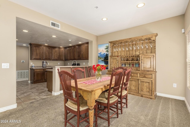 dining area with recessed lighting, visible vents, and light carpet