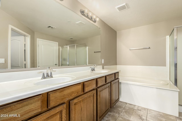 full bath with visible vents, a sink, and a garden tub