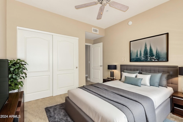 bedroom with light colored carpet, a closet, visible vents, and ceiling fan