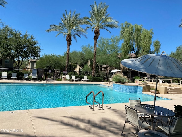 pool featuring a patio and fence