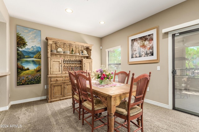 dining room with recessed lighting, dark carpet, and baseboards