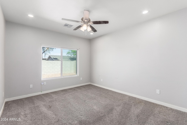 spare room featuring ceiling fan and carpet flooring