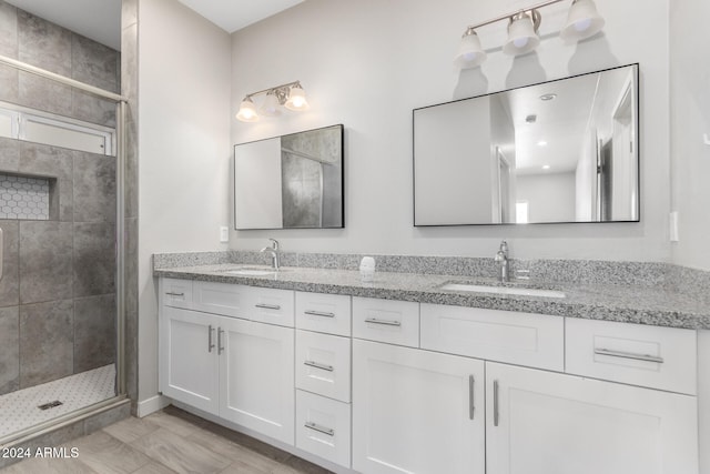 bathroom featuring walk in shower and vanity