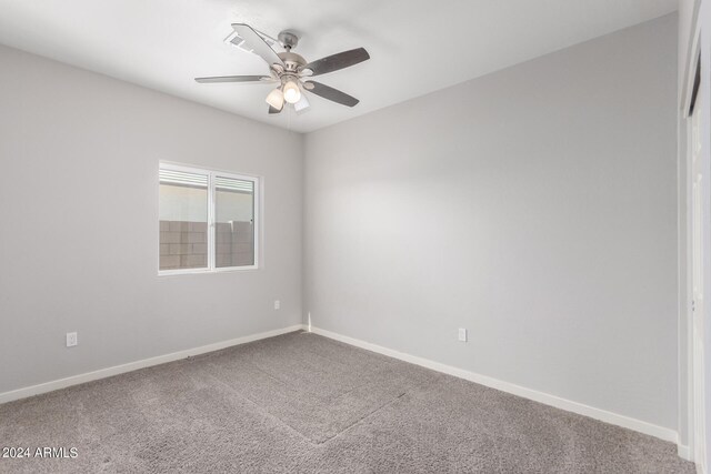 carpeted empty room featuring ceiling fan