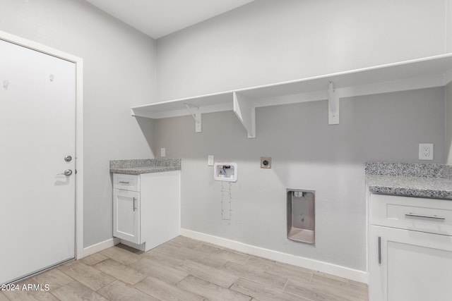 washroom with light hardwood / wood-style floors, hookup for an electric dryer, hookup for a washing machine, and cabinets