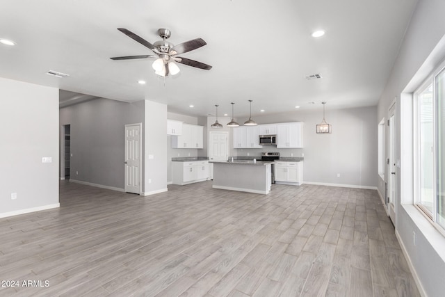 unfurnished living room with ceiling fan and light hardwood / wood-style floors