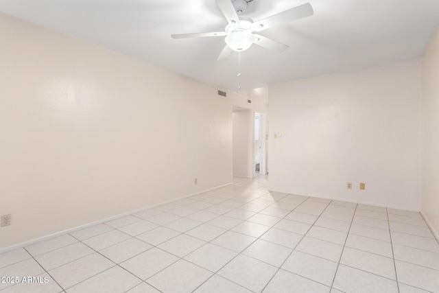 empty room with ceiling fan and light tile patterned flooring