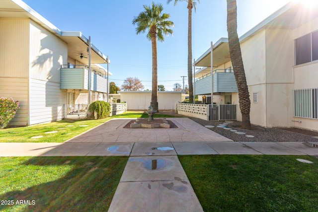 view of home's community with a yard and a patio area