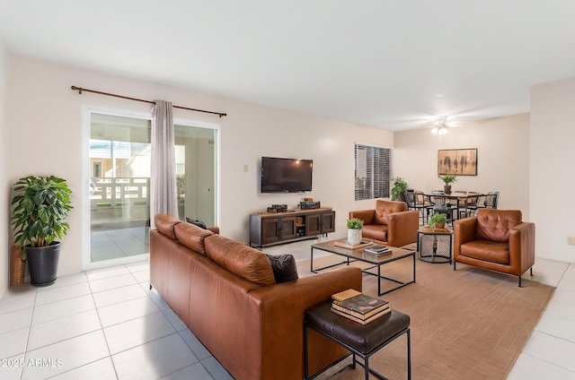 living room featuring ceiling fan and light tile patterned floors