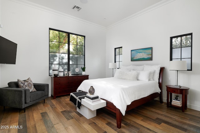 bedroom with crown molding and dark hardwood / wood-style floors