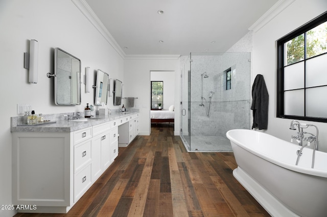 bathroom featuring vanity, hardwood / wood-style floors, ornamental molding, and plus walk in shower