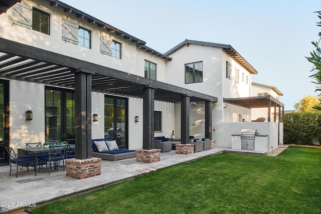 back of house featuring a yard, an outdoor living space, and a patio area