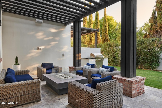 view of patio featuring an outdoor kitchen, an outdoor living space with a fire pit, and a pergola