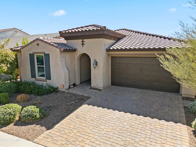 mediterranean / spanish-style home with a garage