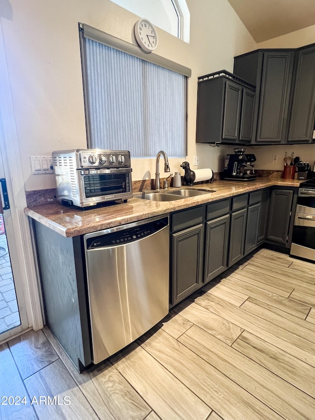 kitchen with light hardwood / wood-style floors, sink, and appliances with stainless steel finishes