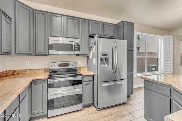 kitchen featuring gray cabinets and appliances with stainless steel finishes