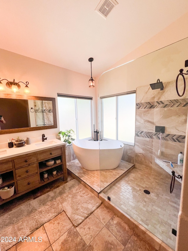 bathroom with tile patterned flooring, vanity, and shower with separate bathtub