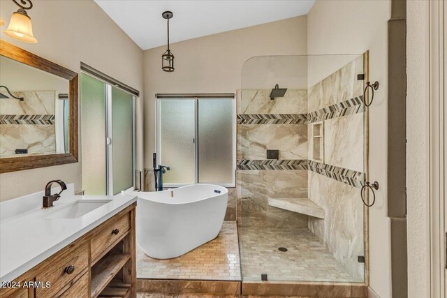 bathroom with vanity, independent shower and bath, and lofted ceiling