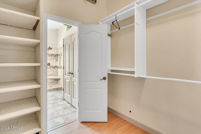 spacious closet with hardwood / wood-style floors