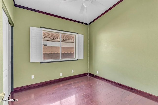 unfurnished room featuring ceiling fan, hardwood / wood-style flooring, and crown molding